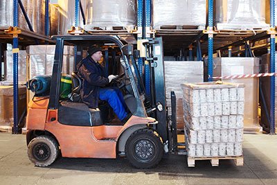 Warehouse worker operating a propane forklift