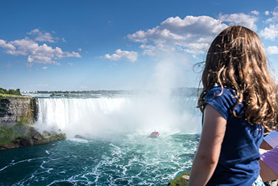 Girl looking at a waterfall